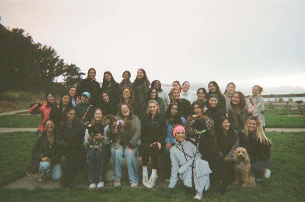 About thirty women on a Cherry walk in San Francisco, the Golden Gate behind them in fog